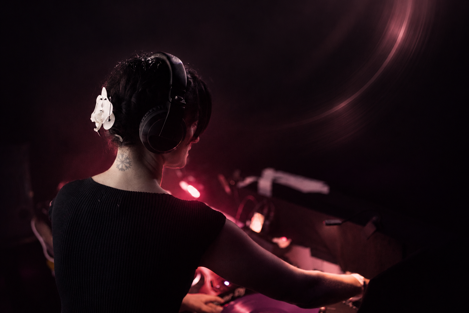 Cat Gadget wearing headphones behind the decks