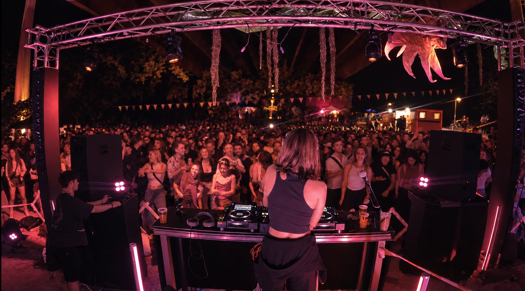 A shared dancefloor in soft pink light